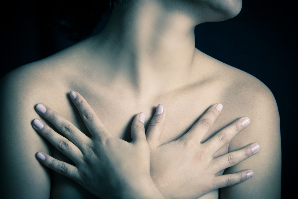 A Woman Covering Her Breasts from Stretch Marks
